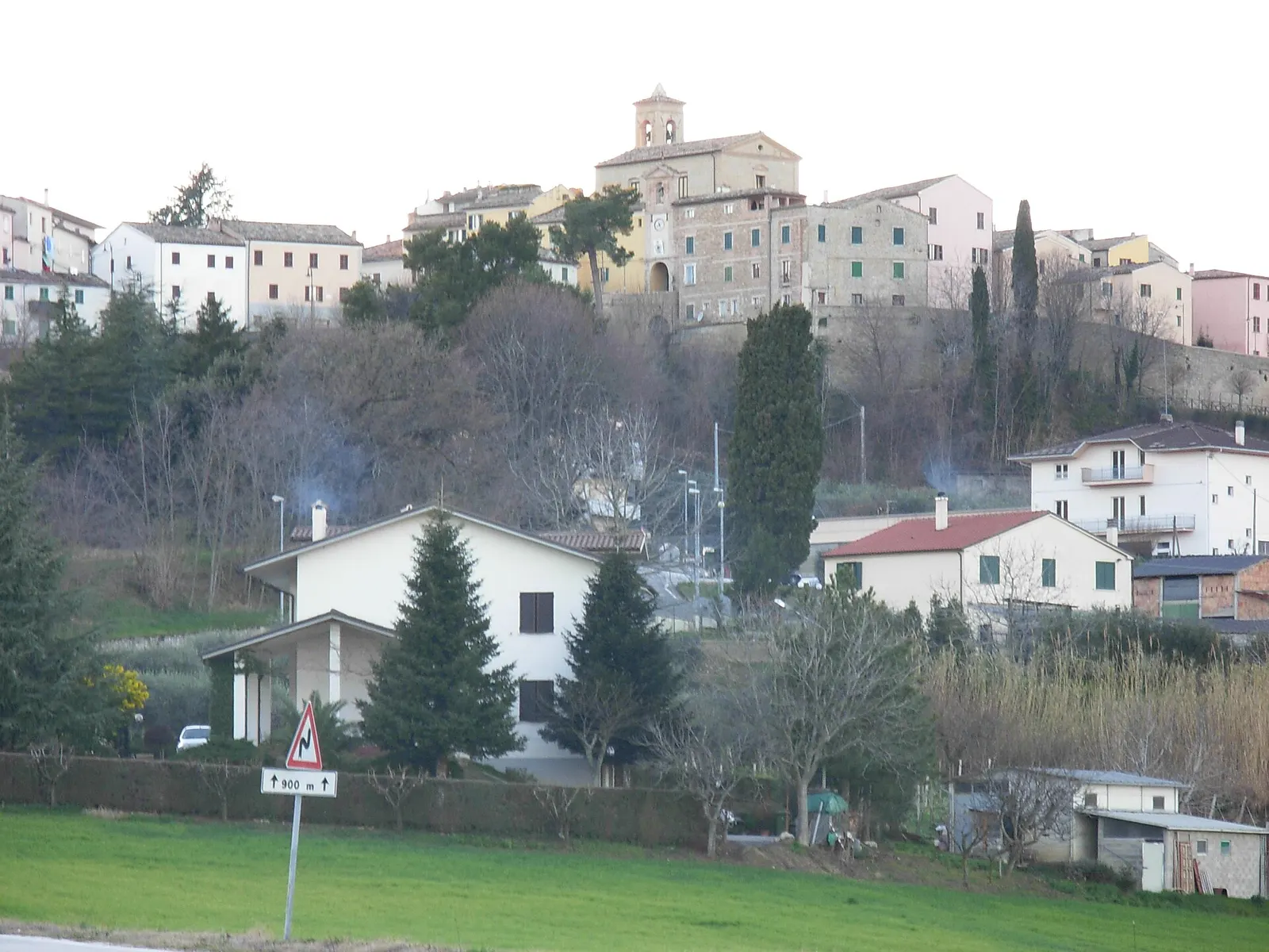 Veduta del borgo di Mergo arroccato sulla collina con case storiche e campanile nella provincia di Ancona