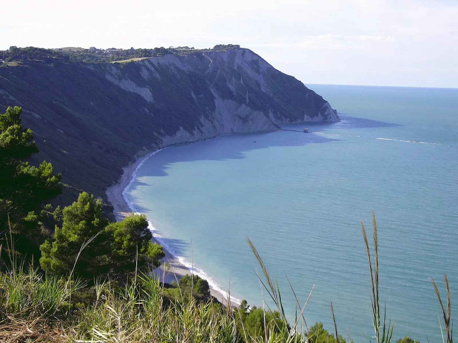 Baia di Mezzavalle vista dall'alto con spiaggia bianca e scogliera del Conero sul mare Adriatico ad Ancona